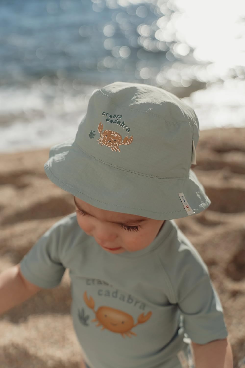 Sonnenhut wendbar - Ocean Surfe Blue grün / weiß (Gr. 0-12 Monate)